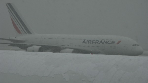 AF A380 taxiing to the gate from CDG (seen over  the ice and snow covered fuselage of one of the AZ A330's)